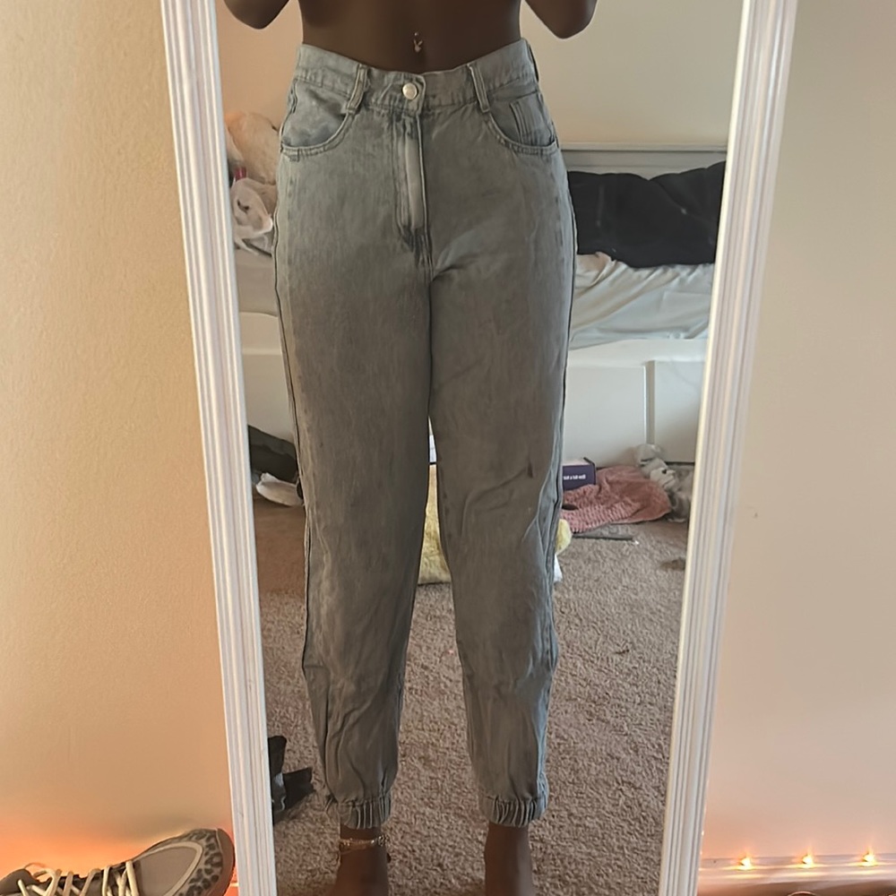 Blue jeans cuffed at the bottom, rarely worn basically new